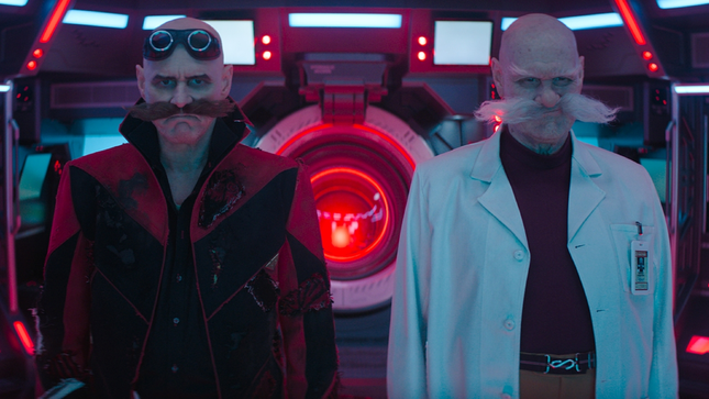 The robotniks watch something off-screen on a futuristic ship.